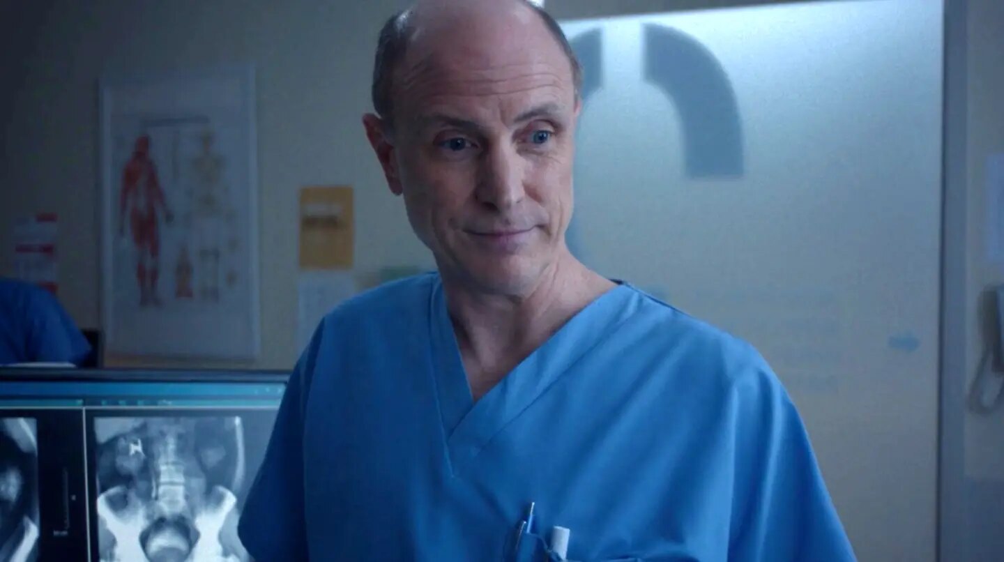 Drew Moore as Dr. Son in the examination room