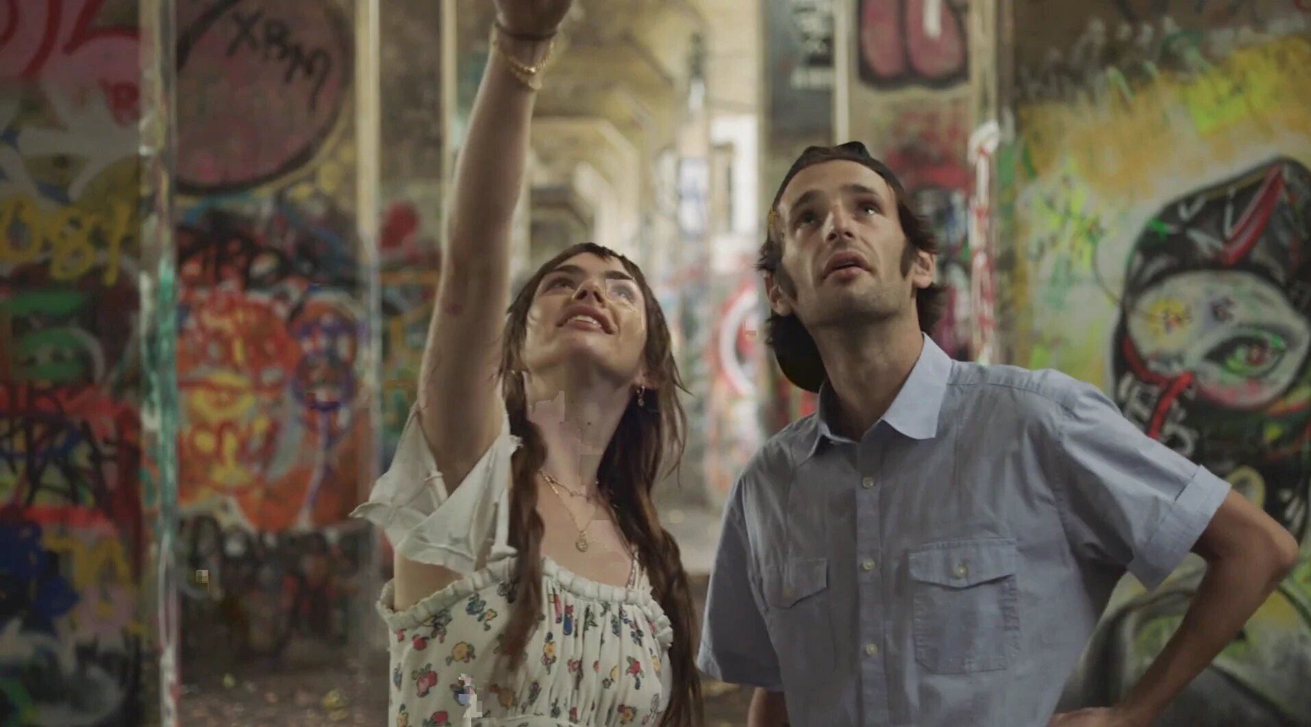 Jane and Frankie looking up amid painted walls